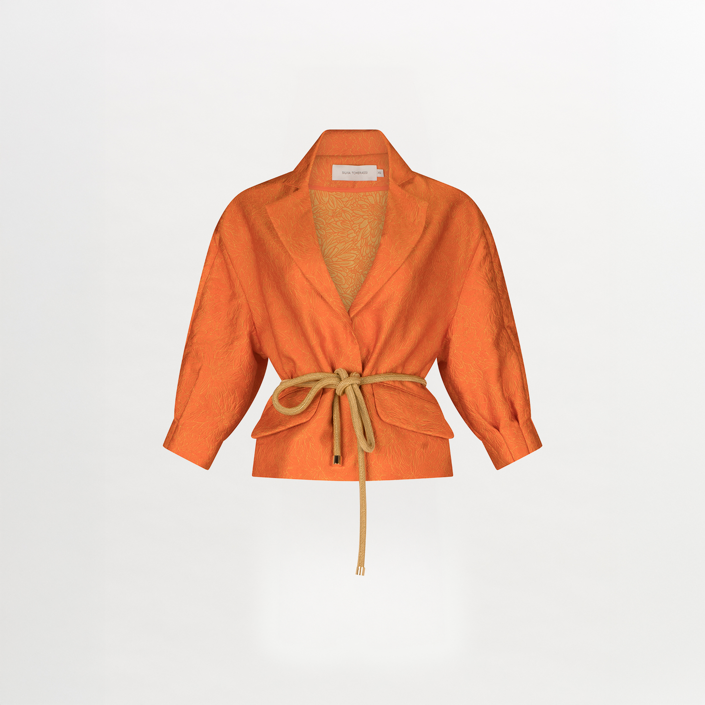 A women's Gianna Jacket Orange Petal with a belt, featuring a relaxed fit.
