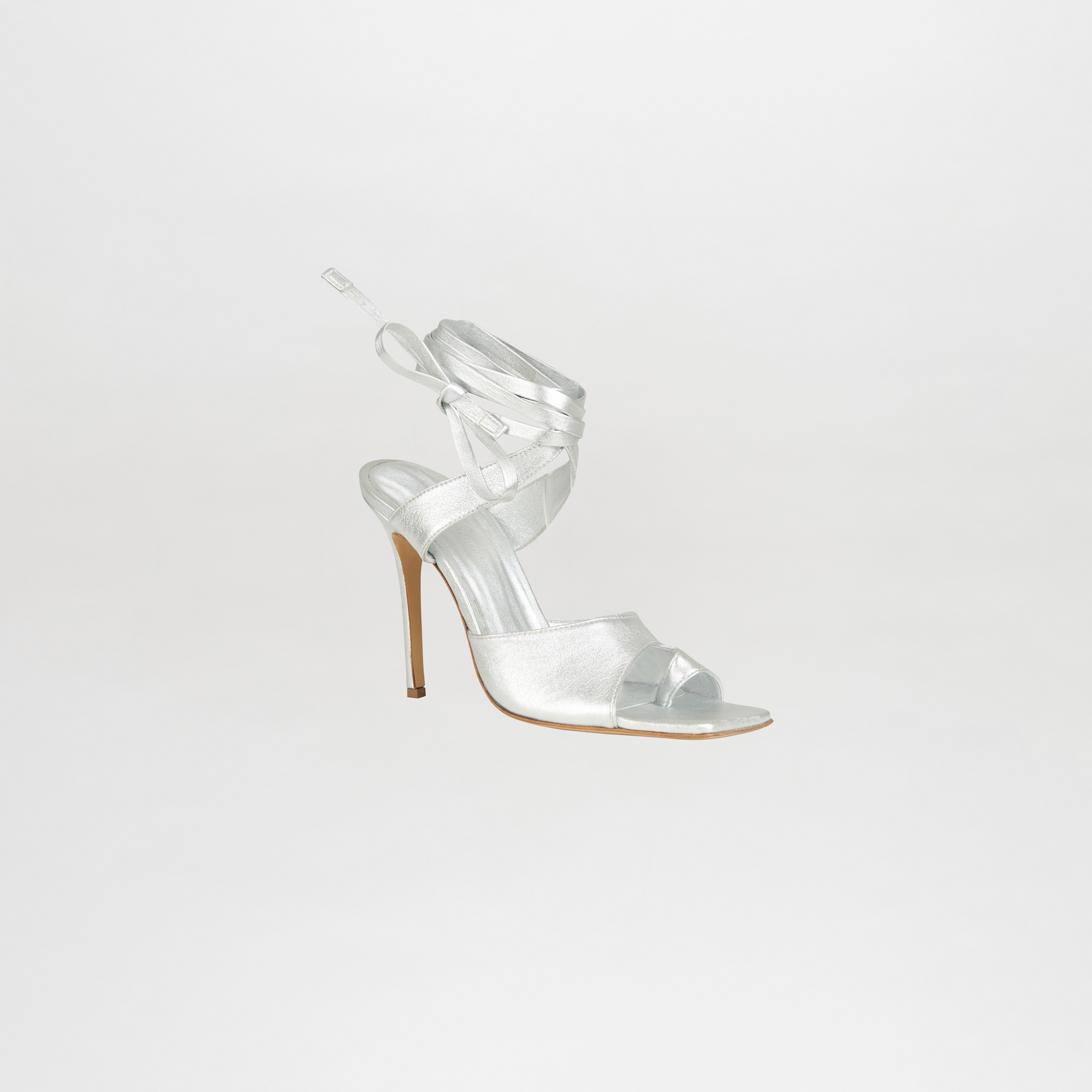Clear high-heeled sandal on a light gray background