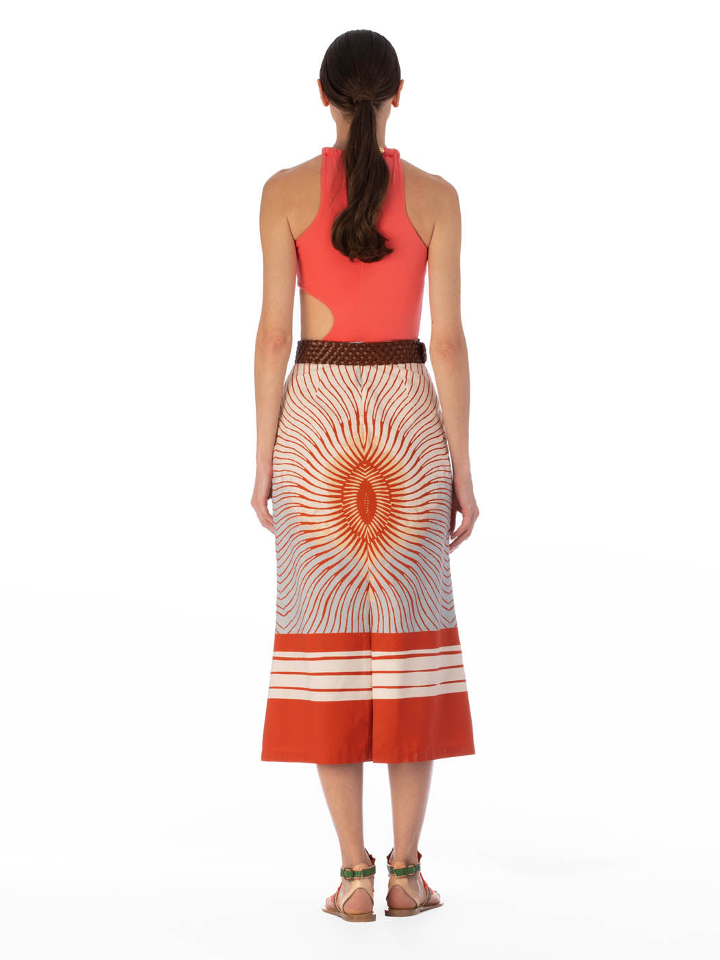 Long high-waisted Atira Skirt Sausalito Sunset with an orange and white sunburst pattern and horizontal stripes at the hem.