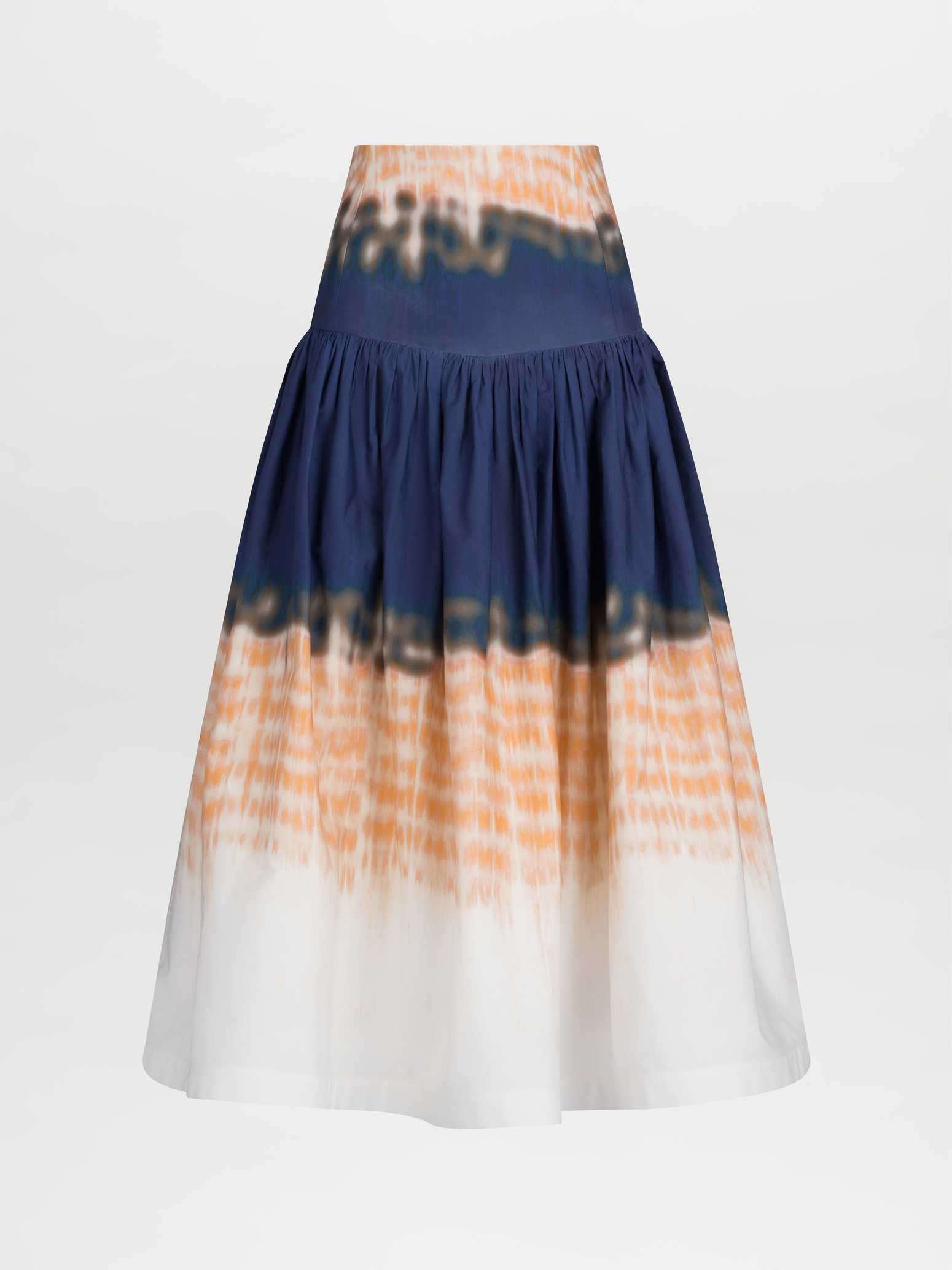 The Halsey Skirt Mediterranean Coral Blue is a high-waisted, flared midi skirt crafted from 100% cotton. It features an abstract multicolor print in navy, orange, and white with a vibrant tie-dye pattern that adds a playful touch to any ensemble.