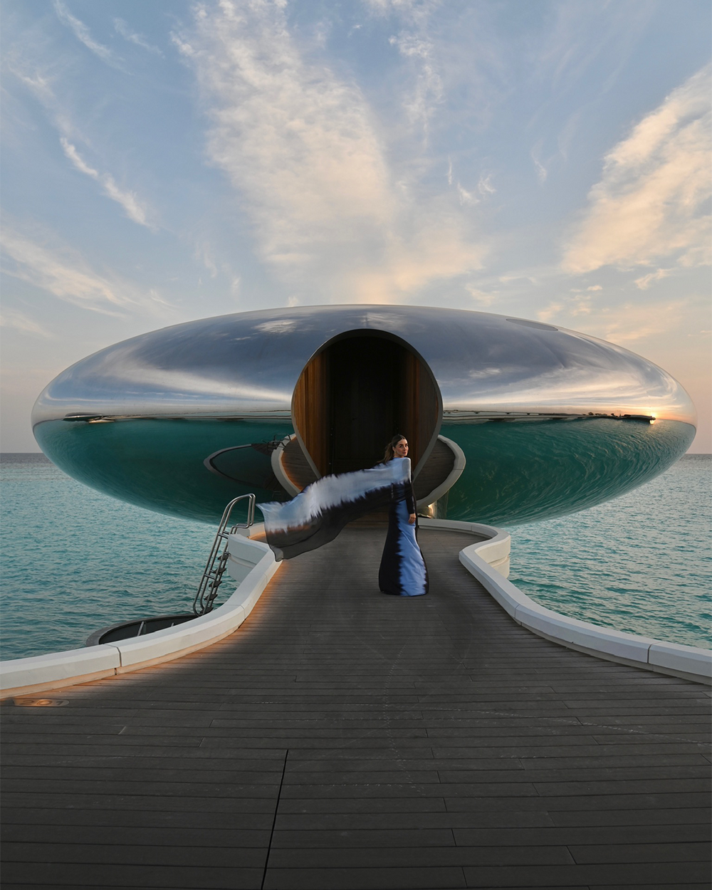Modern architectural structure resembling a futuristic spaceship on a waterfront.