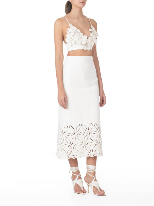 Atira Skirt Pearl high-waisted midi skirt with laser-cut floral hem design, isolated on a white background.