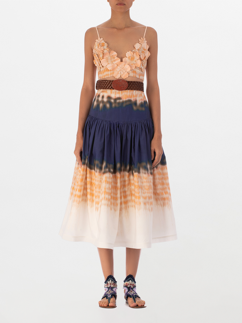 The Ibbie Top Mediterranean Coral Blue is a crop top bralette with spaghetti straps, showcasing exquisite floral detailing and 3D flower embellishments in soft shades of peach and beige on a plain white background.
