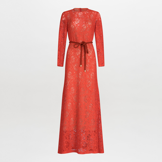 The Ida Dress is an enchanting long-sleeve maxi, designed with red lace and intricate patterns. It features an A-line skirt and cinches elegantly at the waist with a brown belt, all displayed on a plain white background.