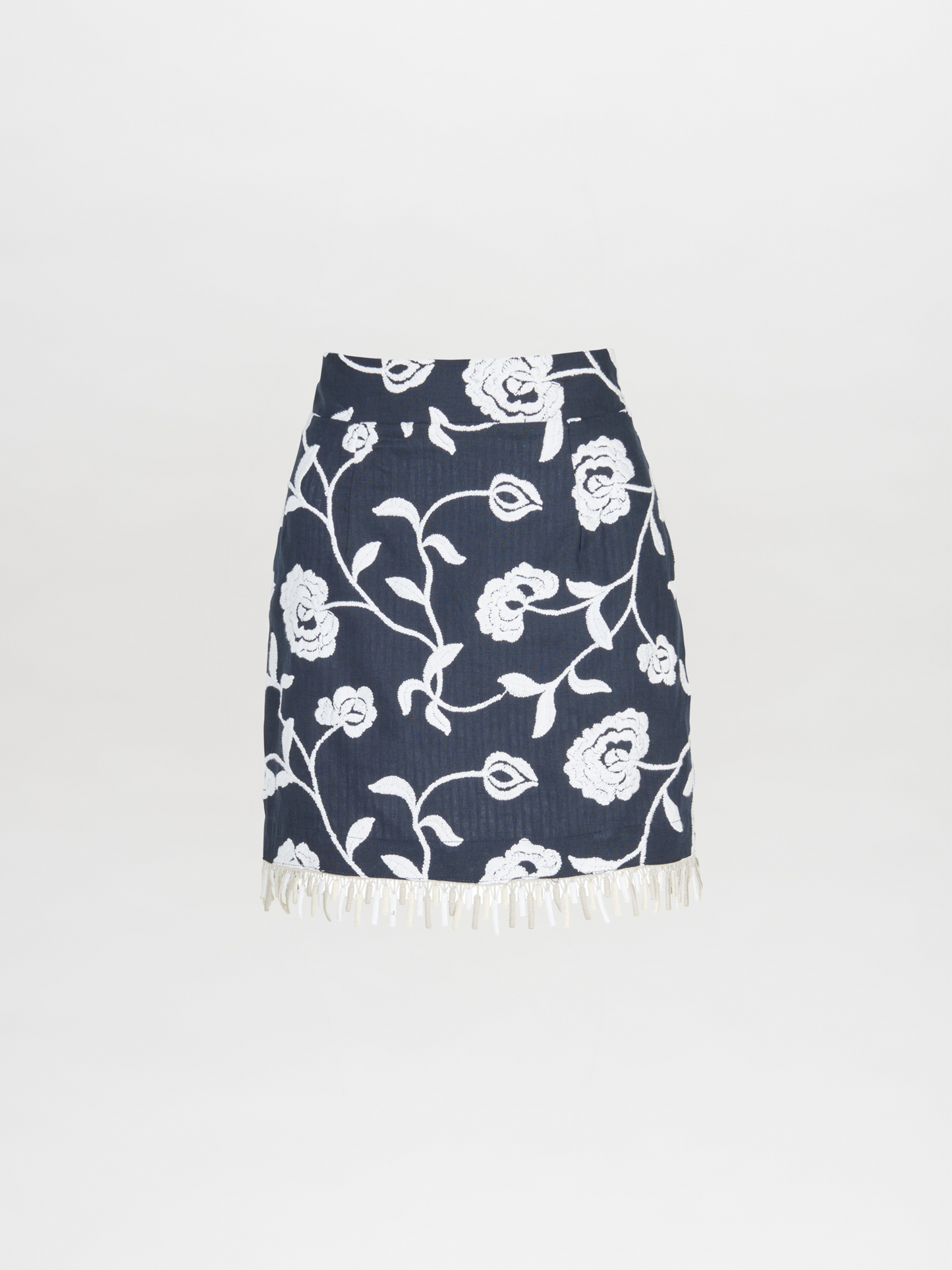 An Idalia Skirt Navy Embroidered with fringes.