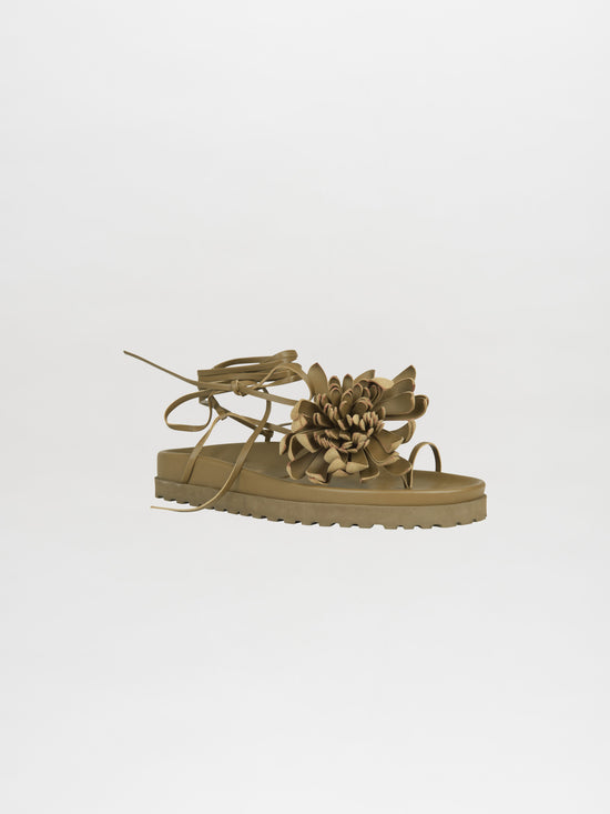 The Idania Sandal Olive features a floral design on the strap and a thick sole, perfect for adding a touch of style to your outfit. Order effortlessly now for smooth processing and enjoy quick delivery straight to your doorstep.