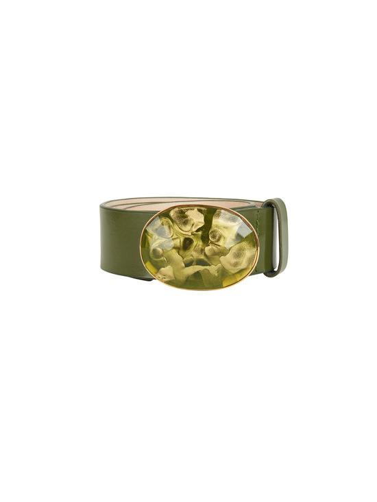 The Irene Belt Olive is a green Italian leather accessory, adorned with a large oval resin buckle that features an abstract textured design, making it perfect for Fall 2023.