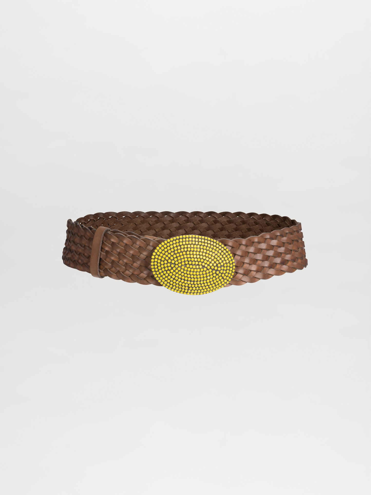 The Irene Belt Lime by Tcherassi spotlights a large yellow beaded oval buckle set against a brown braided leather belt, elegantly displayed on a plain white background.