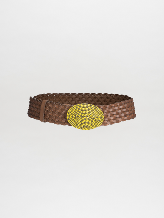 The Irene Belt Lime by Tcherassi spotlights a large yellow beaded oval buckle set against a brown braided leather belt, elegantly displayed on a plain white background.