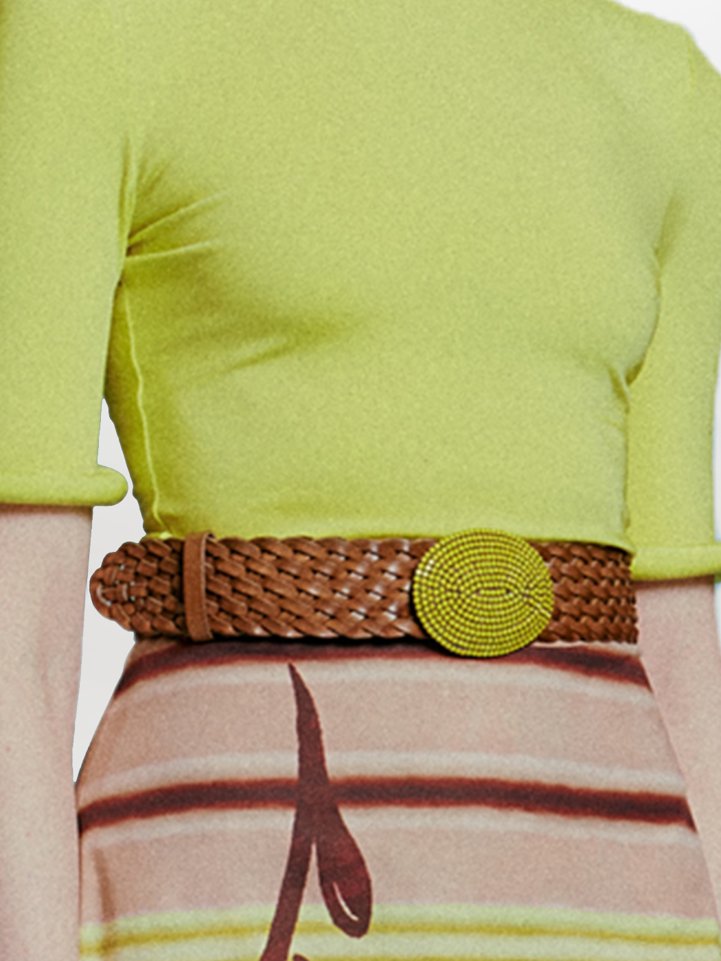 The Irene Belt is a braided leather accessory with a bold round yellow beaded buckle set against a pristine white background.