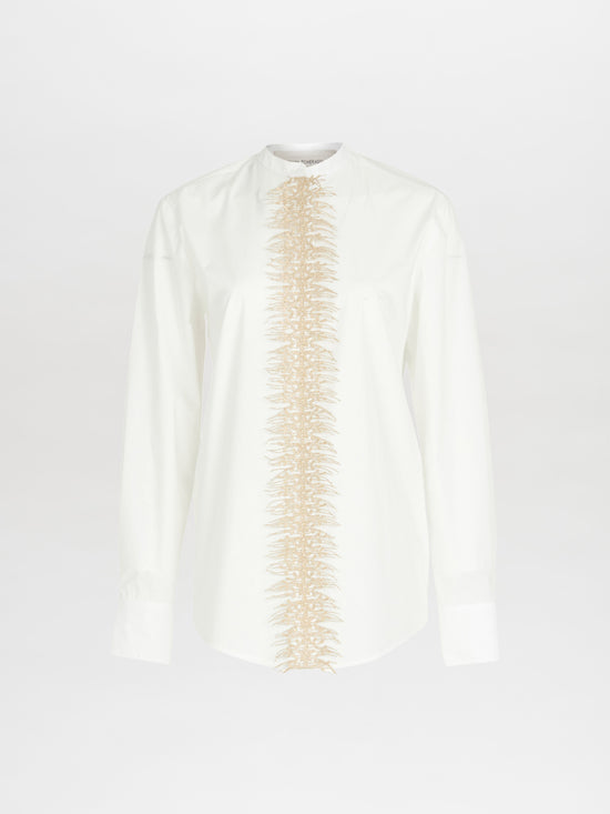 Isabel Blouse White, a long-sleeve top made from cotton poplin, showcases a vertical beige textured design down the center.