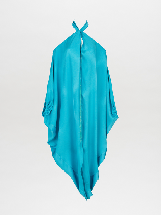 A Jacqueline Kaftan Turquoise with a halter neck and draped design, made from turquoise crepe fabric and featuring loose, flowing material.