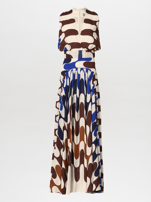 The Jael Dress Blue features long sleeves and a flowing skirt, adorned with an elegant geometric pattern in shades of brown, white, and blue that drapes gracefully to the floor.