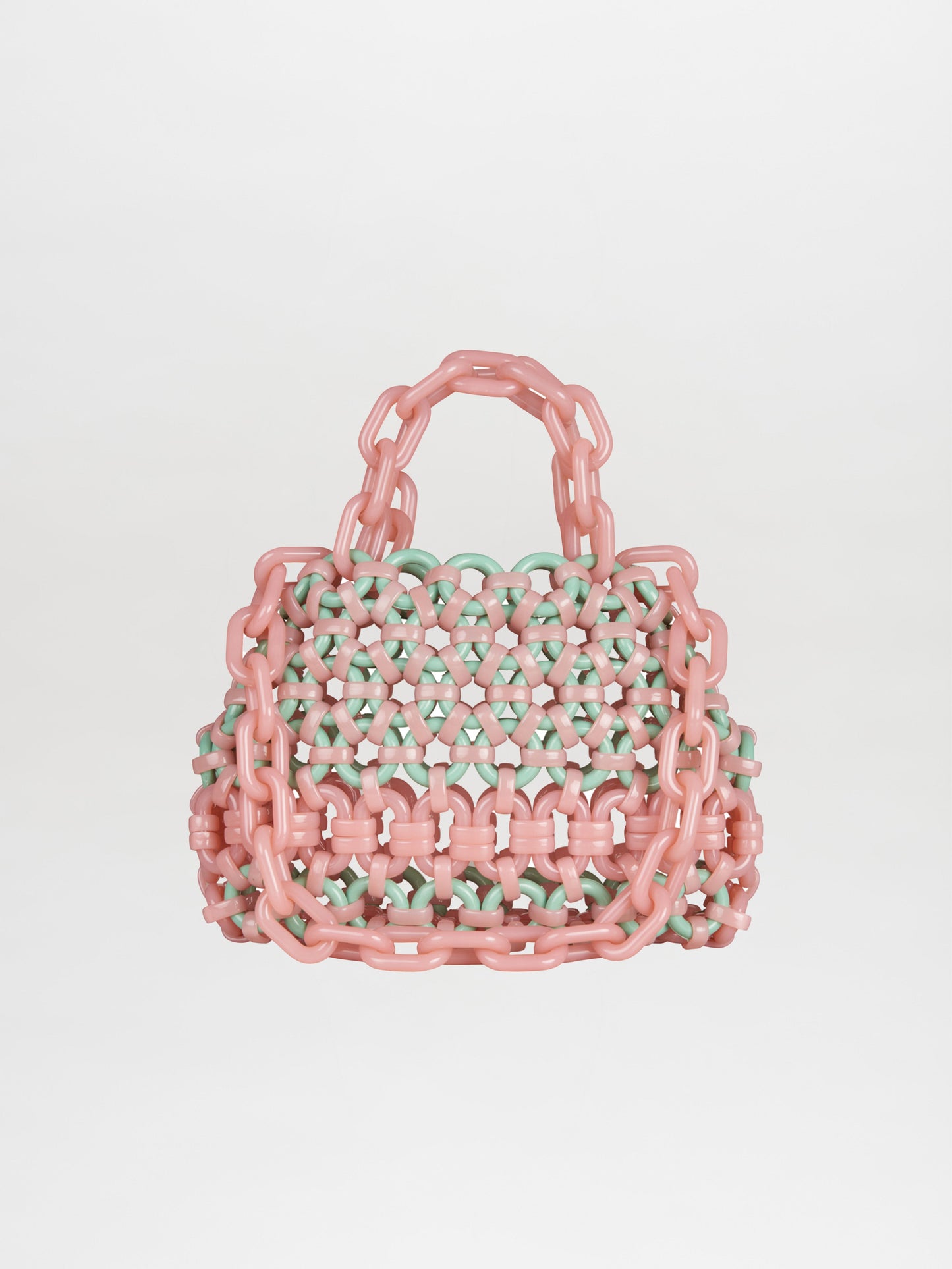 The Jasna Handbag Nude Turquoise, crafted from interlocking pink and green chains with two top handles, is available for swift shipping.