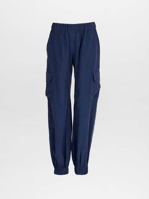 A pair of Jess Pant Navy with an elastic waistband and pockets.