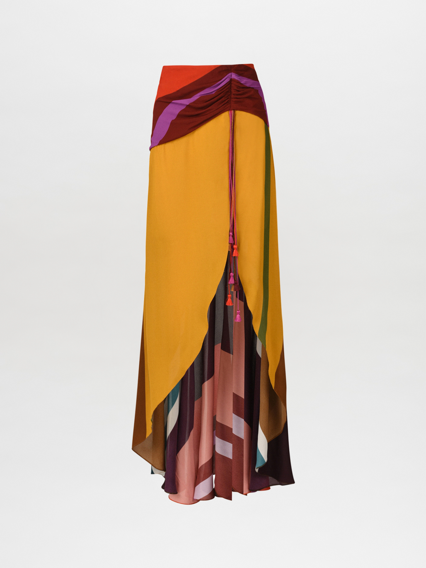 The Karla Skirt Color Block Multi is a luxurious viscose fabric skirt with a gathered waist, showcasing vibrant multicolored geometric patterns in shades of yellow, red, and purple.