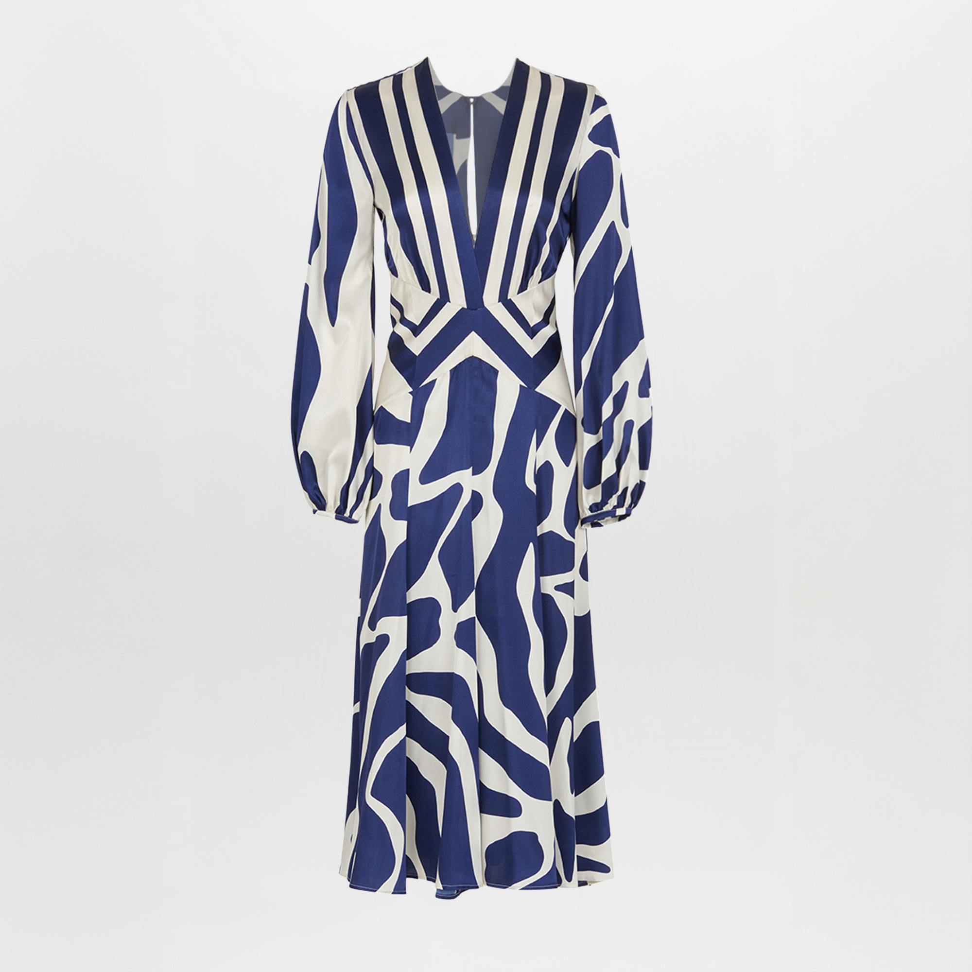 The Kathryn Dress Navy White Mosaic is a knee-length piece with a deep V-neckline and long sleeves, featuring a bold blue and white mosaic print that captures the essence of Spring 2023.