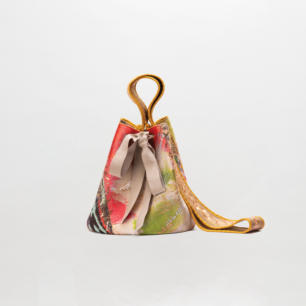 Colorful handbag with a floral pattern on a light gray background