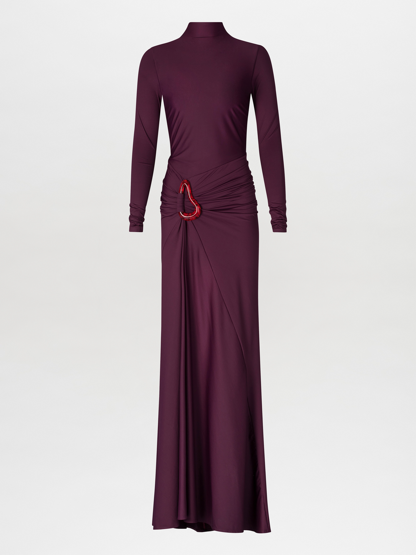 A person in a fitted, long-sleeve Lena Dress Burgundy with a high neckline stands against a plain blue background. The gown, perfect for an August 19th, 2024 gala, features elegant draping and a red embellishment near the waist.