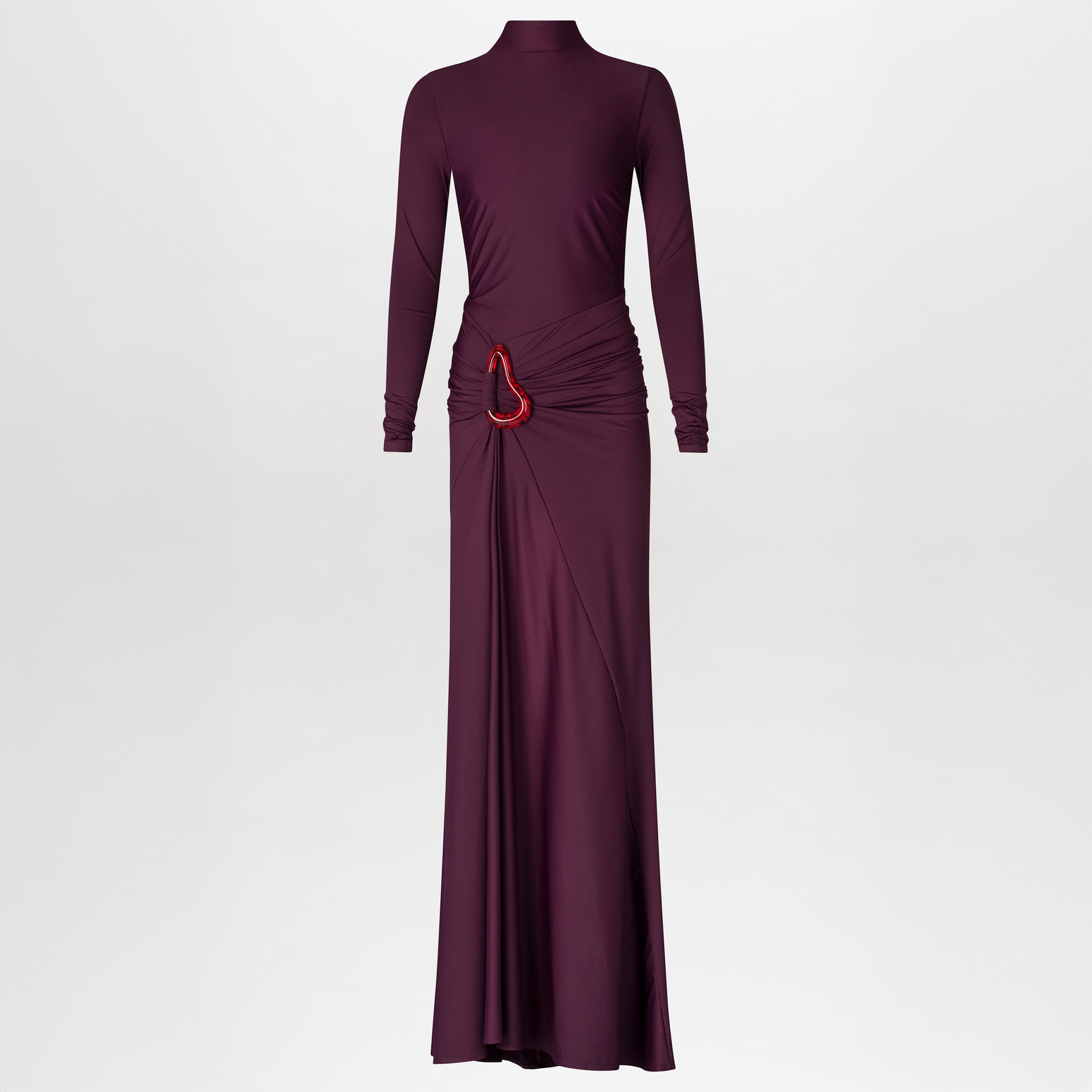 A person in a fitted, long-sleeve Lena Dress Burgundy with a high neckline stands against a plain blue background. The gown, perfect for an August 19th, 2024 gala, features elegant draping and a red embellishment near the waist.