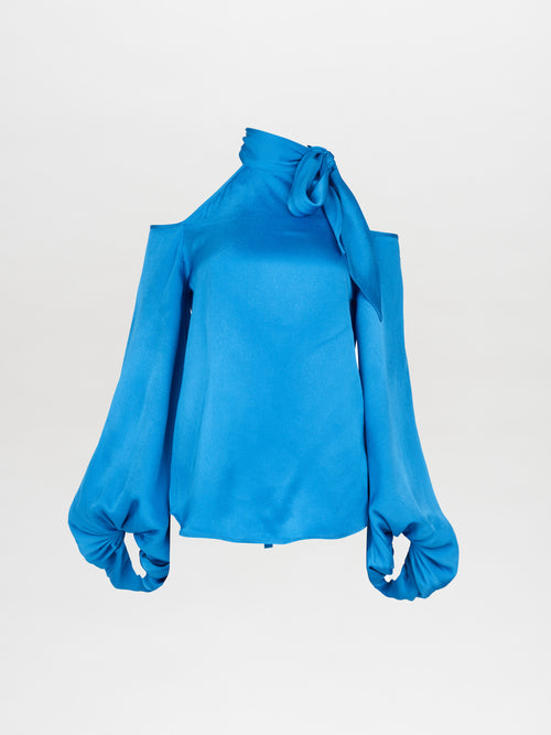 The Ludovica Blouse Blue with a bow on the shoulder, please allow one week for order to ship.