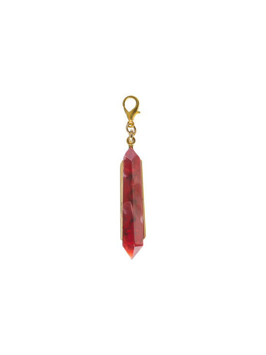 Introducing the Mariela Charm Rouge: A stunning red crystal pendant with a gold setting and clasp, perfect for any occasion. Order now for shipping on September 2nd.