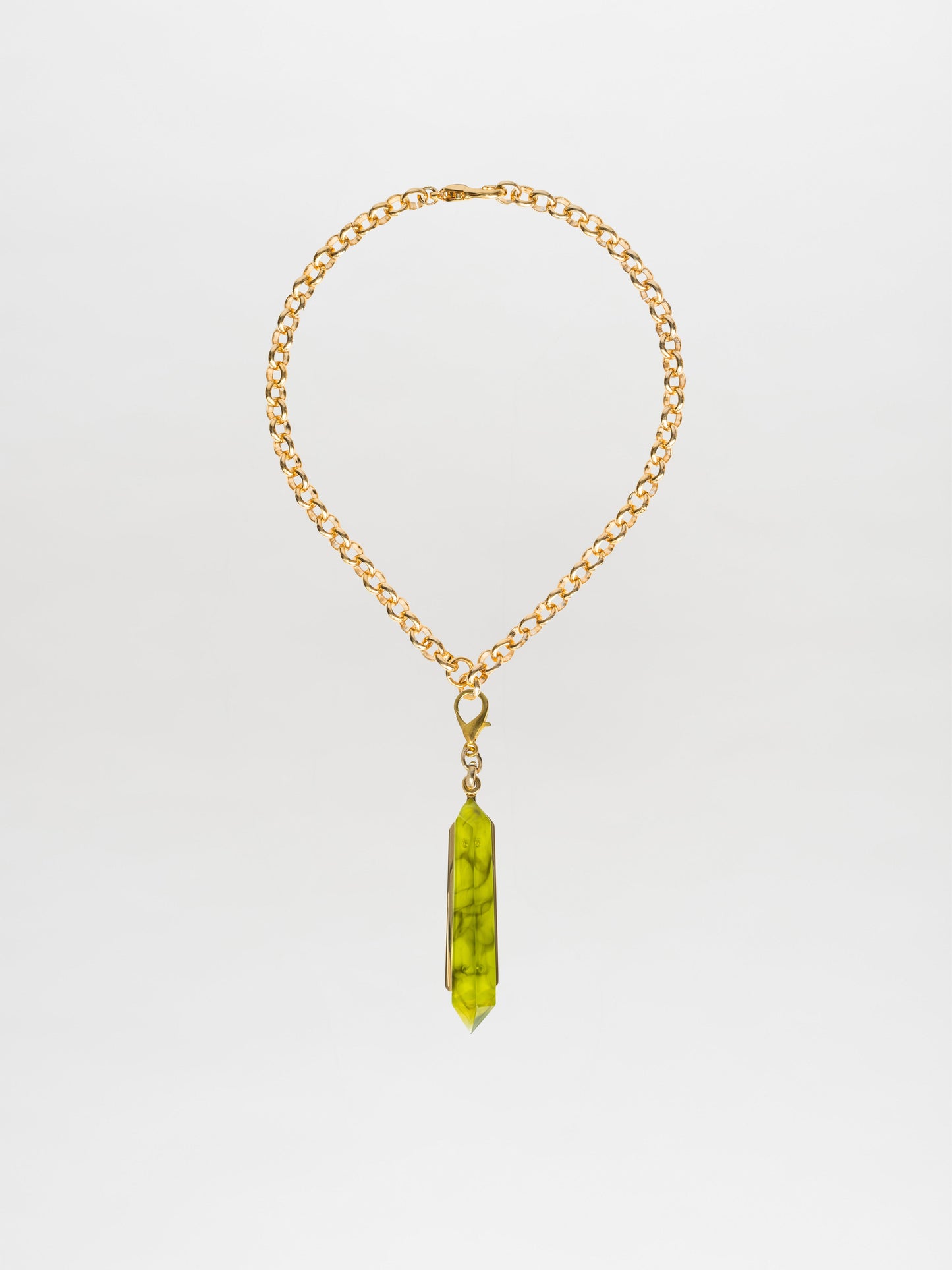 The Mariela Necklace Green features a choker style crafted from gold-plated brass, adorned with a long, green geometric crystal pendant.