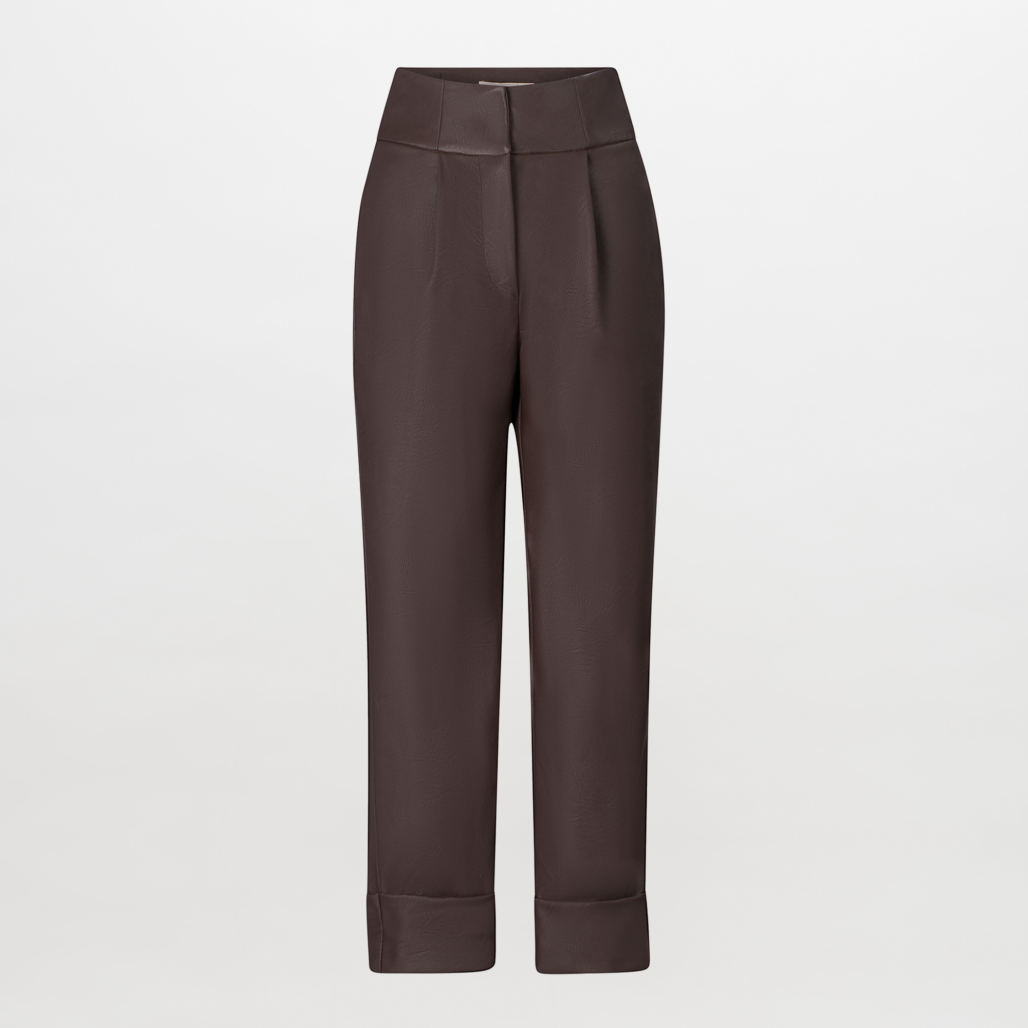 A person is standing against a blue background, wearing a green and brown patterned shirt, dark pants referred to as the "Moad Pant Brown," and gray heeled boots. The shirt is partially tucked into the pants, creating a stylish look perfect for August 19th.