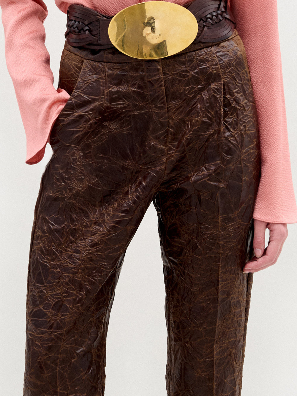 A person stands against a plain background wearing the Moad Pant, a high-waisted cropped style with a straight fitted leg made from Italian fabric.
