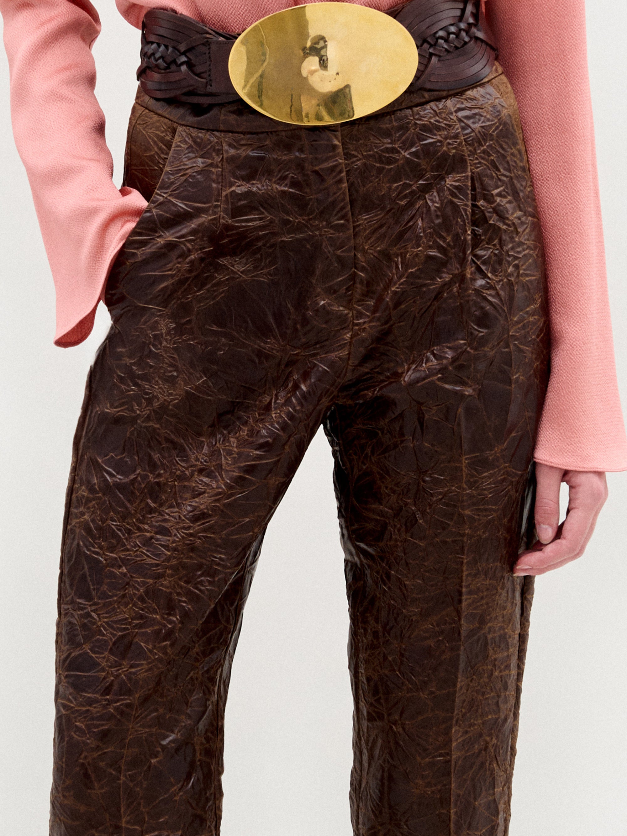 A person stands against a plain background wearing the Moad Pant, a high-waisted cropped style with a straight fitted leg made from Italian fabric.