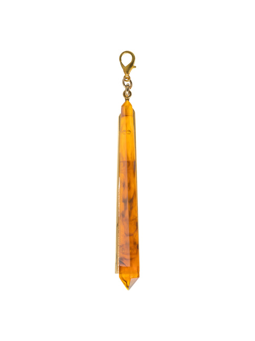 Montse Charm Amber—a yellow-brown crystal pendant with a clasp at the top, featuring a cylindrical, tapered shape. Perfect for accentuating your style on August 19th.