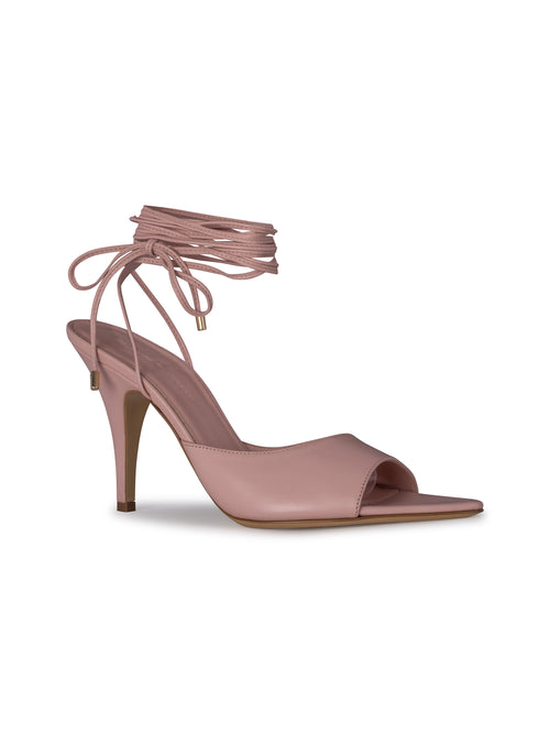 The Muna Heels Pink feature a single pink high-heeled sandal with an open toe and ankle wrap lace-up detail, available for September 2024 delivery.