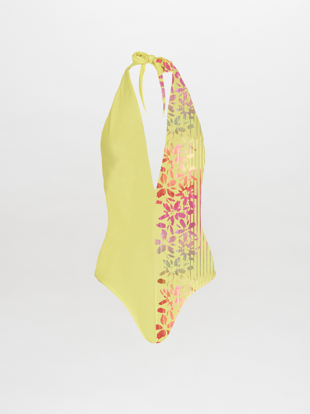 The Macumba Bodysuit Citrine Prismatic is a yellow halter-neck one-piece with a plunging neckline, pink and purple floral pattern, and vertical stripes on one side. This 2023 pre-order item is shown on a plain white background.
