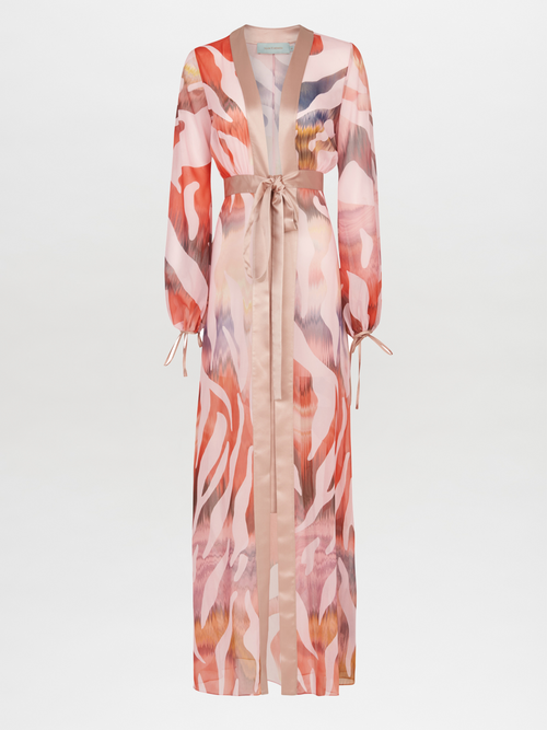 Long-sleeved, pink, and beige patterned robe with a sash belt and wide lapels. The Magdalena Dress Blush Prismatic features abstract zebra print brushstroke designs and tie detailing on the sleeves.