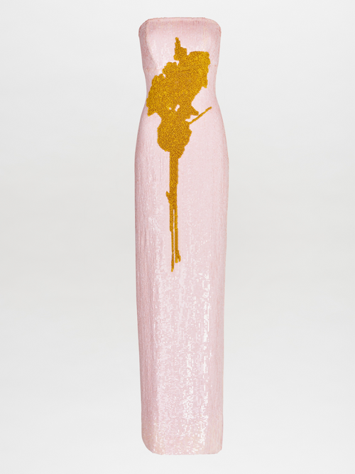 A Margaret Dress Yellow Nude Floral hand-embroidered with a gold flower.