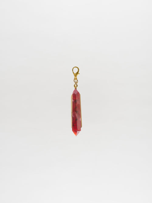 Introducing the Mariela Charm Rouge: A stunning red crystal pendant with a gold setting and clasp, perfect for any occasion. Order now for shipping on September 2nd.