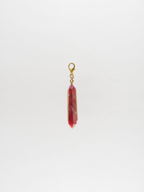 Introducing the Mariela Charm Rouge: A stunning red crystal pendant with a gold setting and clasp, perfect for any occasion. Order now for shipping on September 2nd.