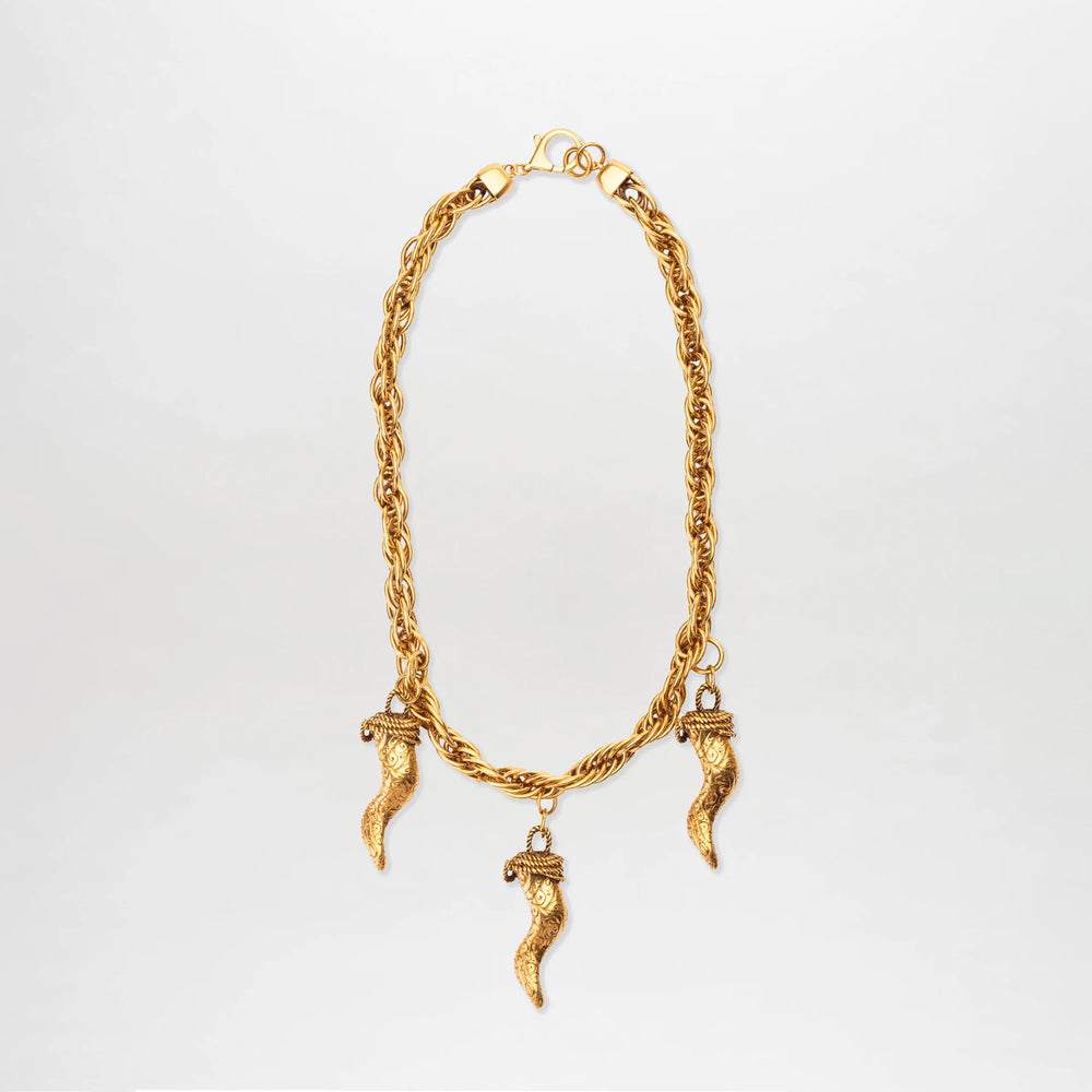The Matilda Necklace is a gold-plated piece with three textured cornicello pendants, each capped with a decorative design, elegantly displayed against a plain white background.