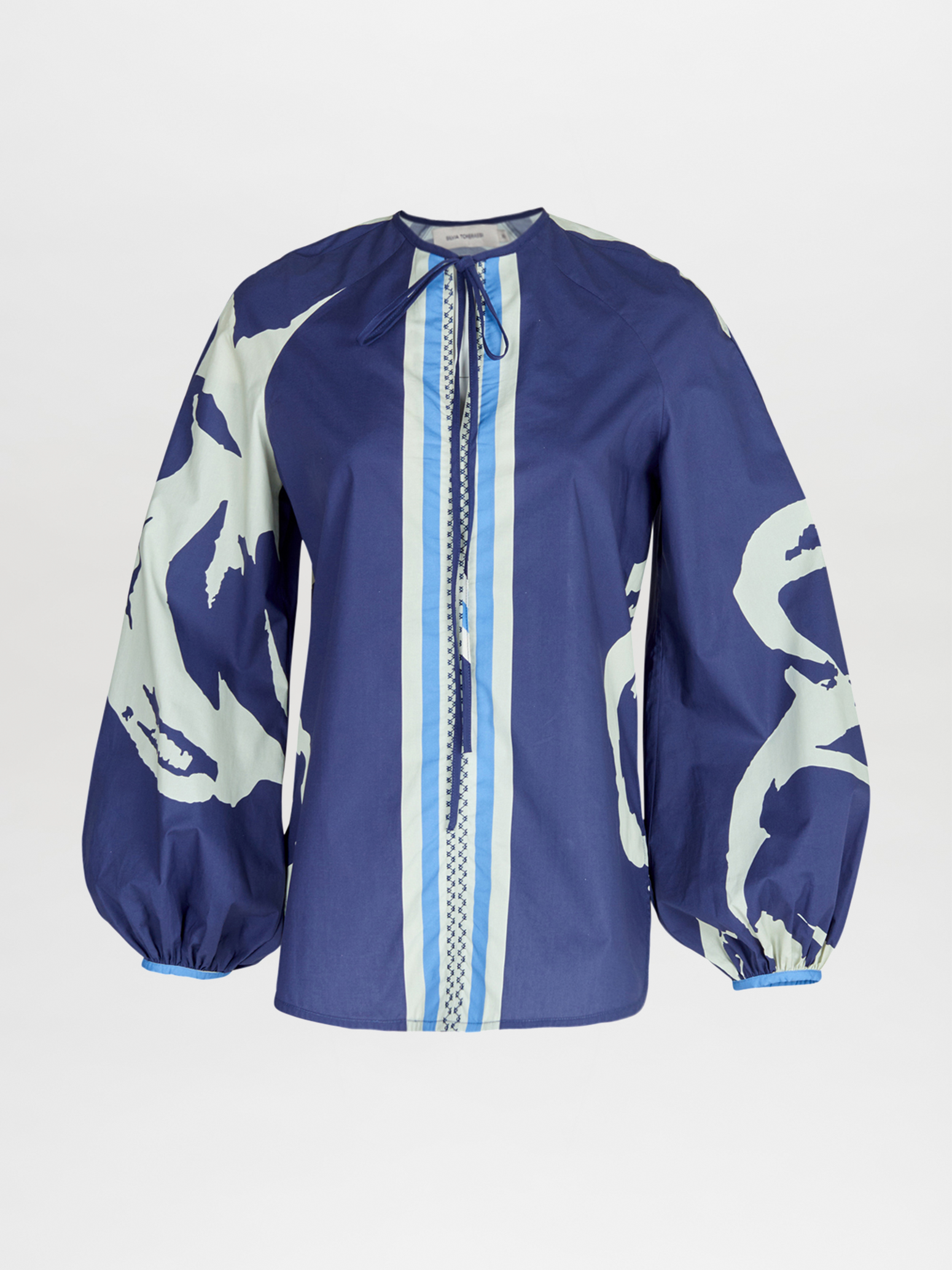 A blue Molveno Blouse Navy Stripes Bloom with a printed white and blue pattern.