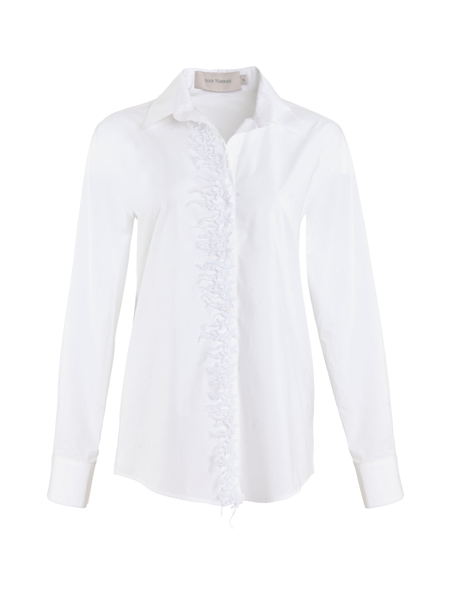 Naroa Blouse White with a ruffled front and long sleeves, isolated on a white background.