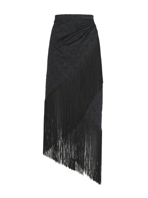 A black skirt with fringes on an asymmetrical hem, resembling the Natalia Skirt Black.