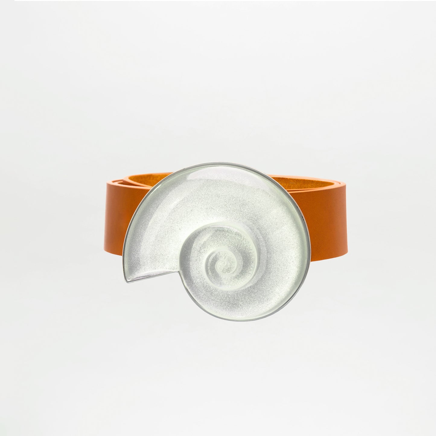 Clear glass dish with brown leather holder on a white background