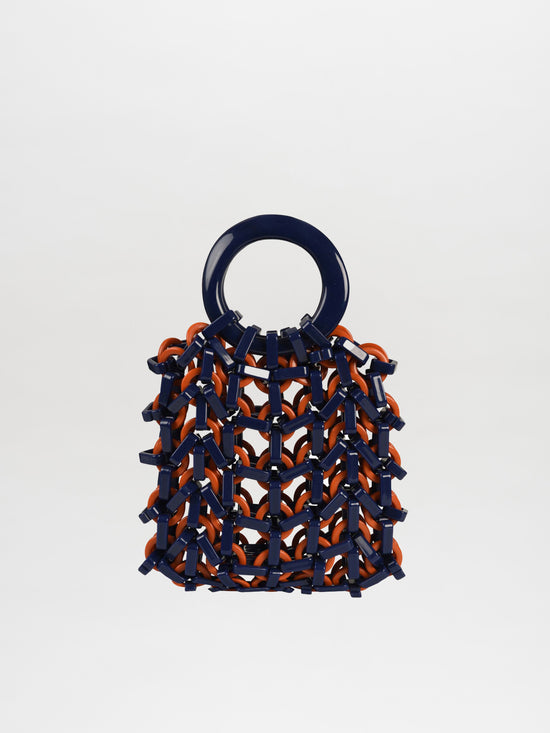 The Omegna Handbag in navy and orange is a stylish accessory featuring a knit-like resin texture and a round handle.