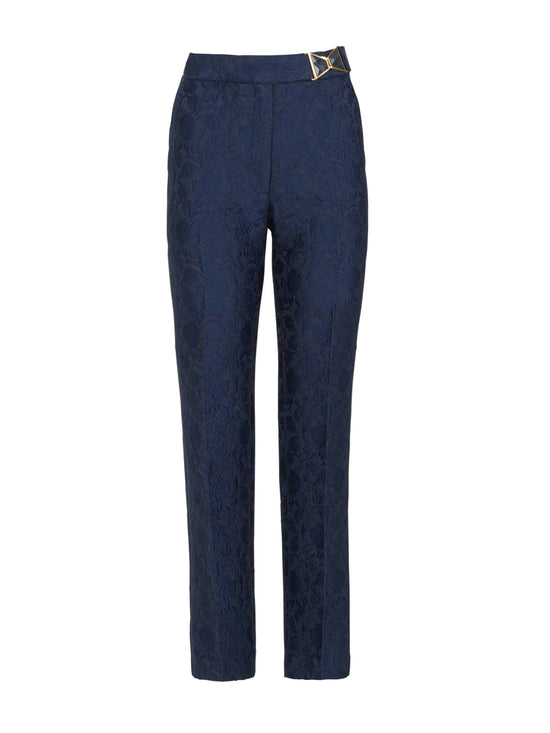 A woman's high-waisted Orion Pant Navy with a gold buckle.