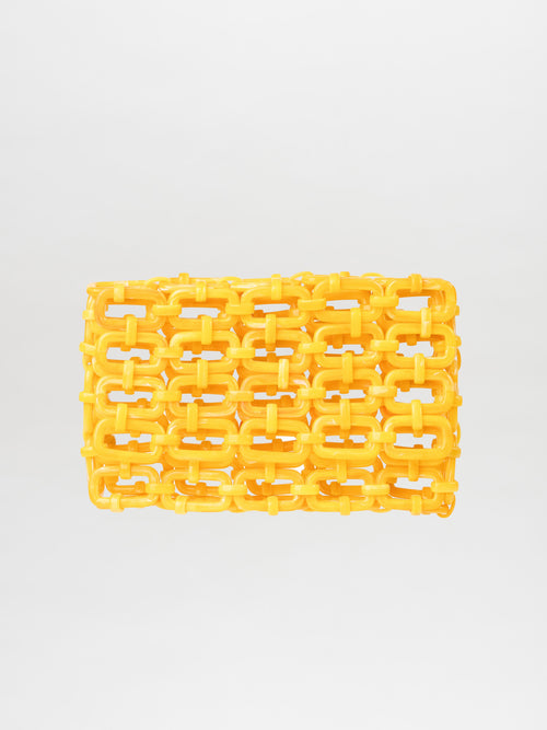 The Orvieto Clutch Limoncello, a yellow woven plastic bag with a grid-like design on a plain background, is a versatile accessory that effortlessly complements any style.