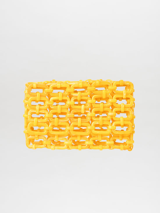 The Orvieto Clutch Limoncello, a yellow woven plastic bag with a grid-like design on a plain background, is a versatile accessory that effortlessly complements any style.