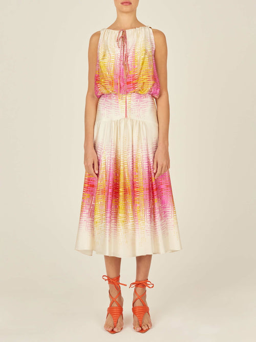 Introducing the Daila Dress White Digital from our Pre Fall 2023 collection, a stunning sleeveless piece featuring a vibrant digital electric print with a gradient of pink, orange, and white. This dress pairs a chic blouson top with a long flowing skirt.