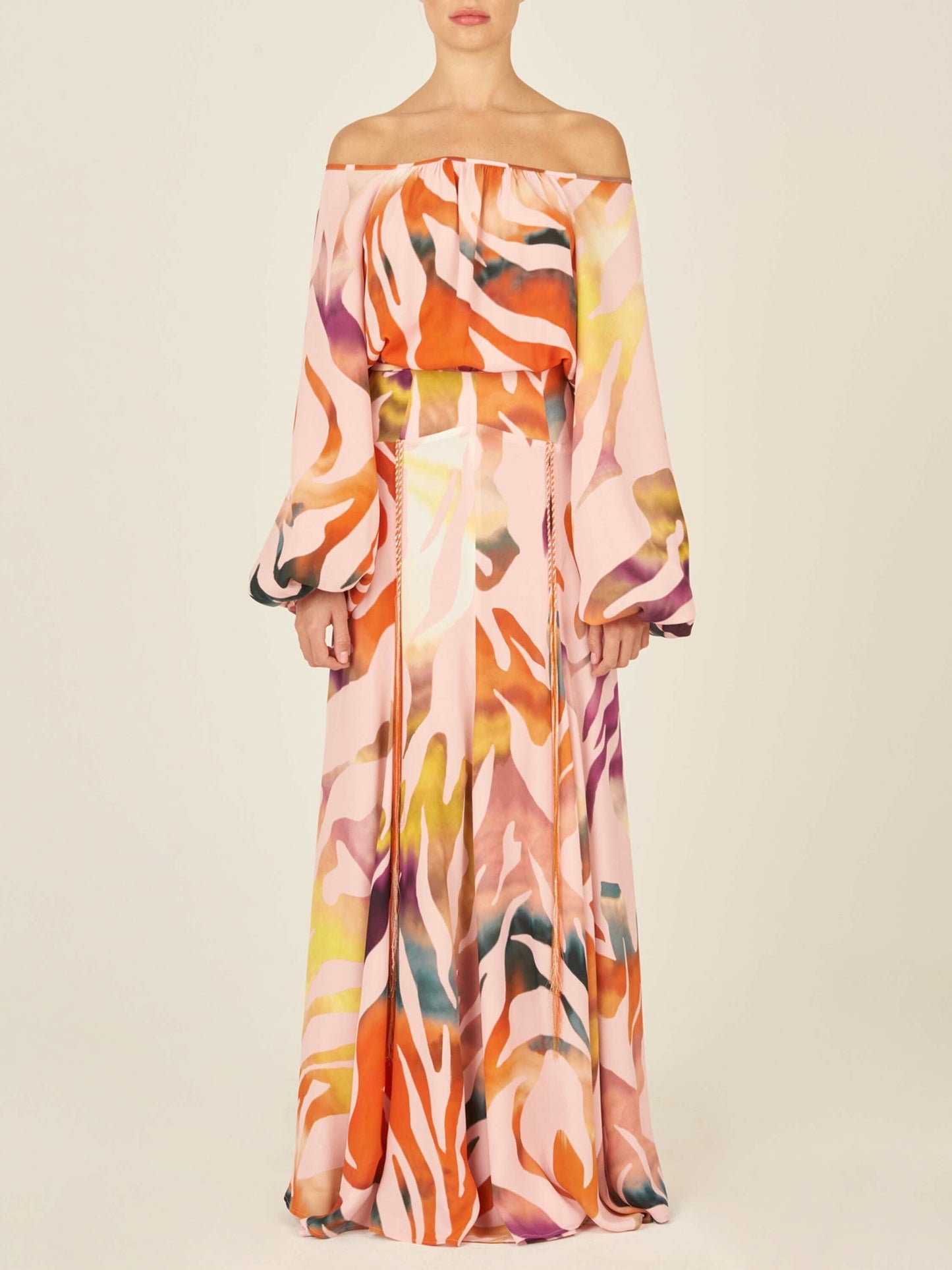 The Iona Skirt Blush Prismatic is a long wrap skirt made from soft viscose fabric, showcasing a multicolored abstract pattern against a plain white background.