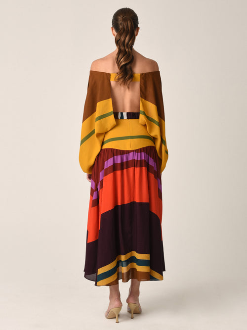 The Mariah Dress Color Block Multi is a multicolored, off-the-shoulder long sleeves ensemble with a wide black belt, featuring color block stripes in shades of yellow, brown, purple, red, and orange.