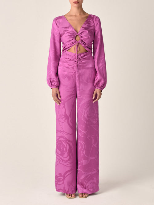 A magenta orchid jacquard, cropped, long-sleeved Odette blouse with a tie-front design and an abstract print, isolated on a white background.